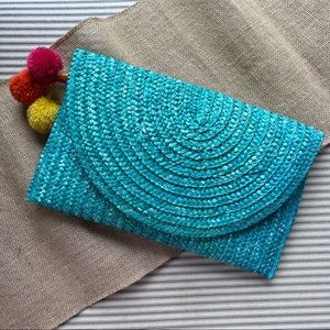 Turquoise beach clutch with pom poms